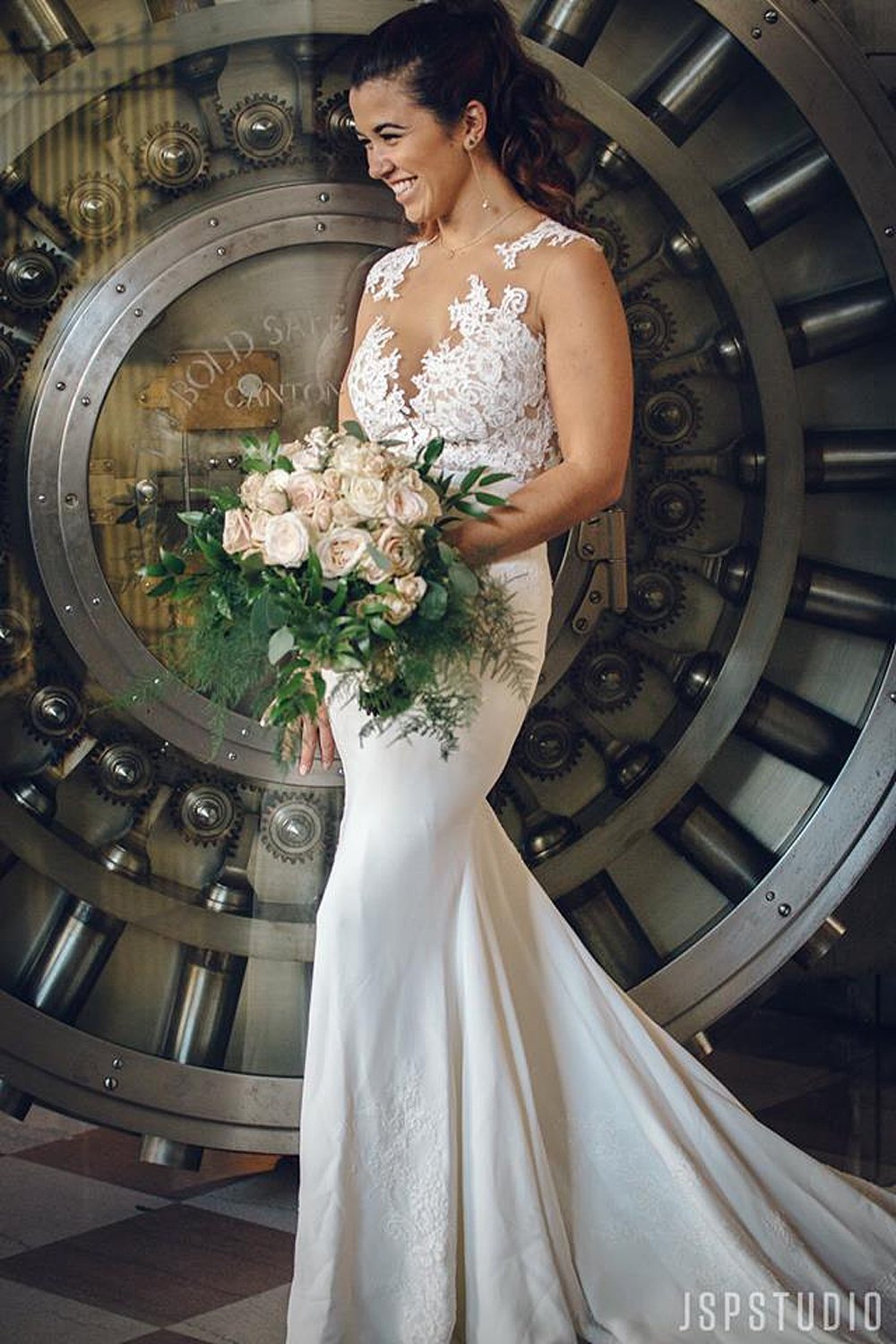 Beautiful Bride in Lace Gown in front of the infamous vault door at the Historic Alfred I Dupont Building 