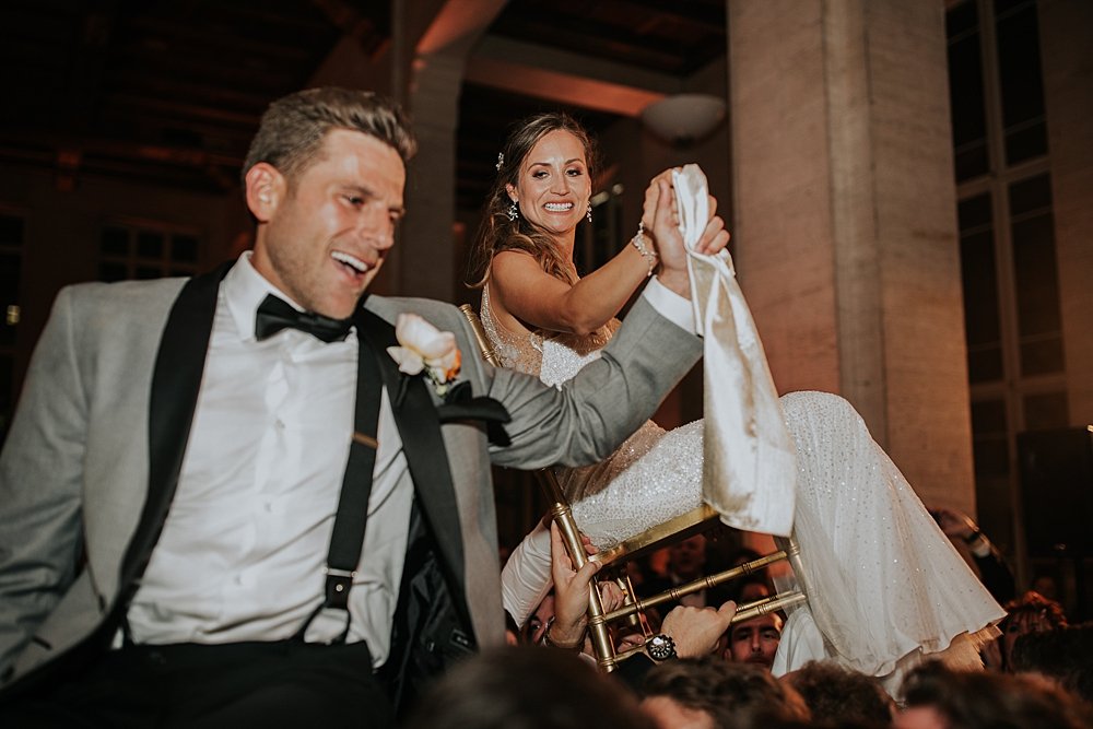 modern-day traditional wedding, bride and groom doing the traditional jewish wedding dance, the hora, miami wedding at the Alfred I Dupont Building