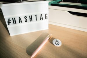 a sign that says hashtag with a pen both sitting on the table.
