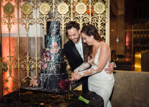 Black and maroon wedding cake at a September wedding at The Historic Alfred I. duPont Building.