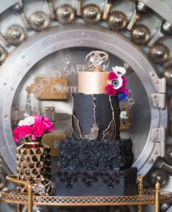 Black wedding cake featuring 2025 wedding cake trends like gold accents