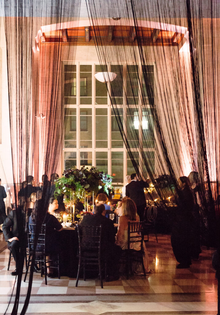 moody wedding décor Miami ceremony with black chairs and candlelight