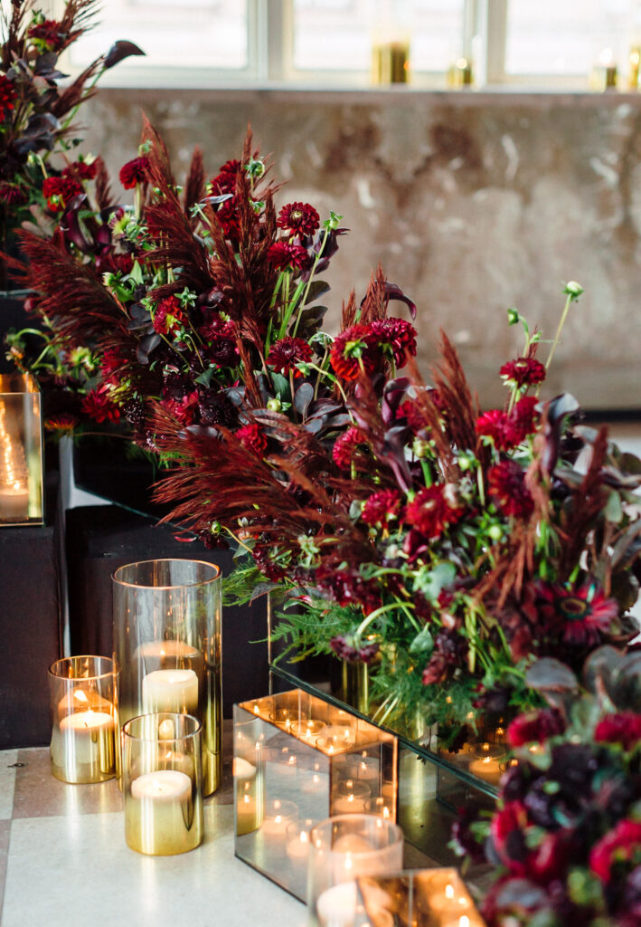 luxury reception moody wedding décor Miami with deep burgundy florals