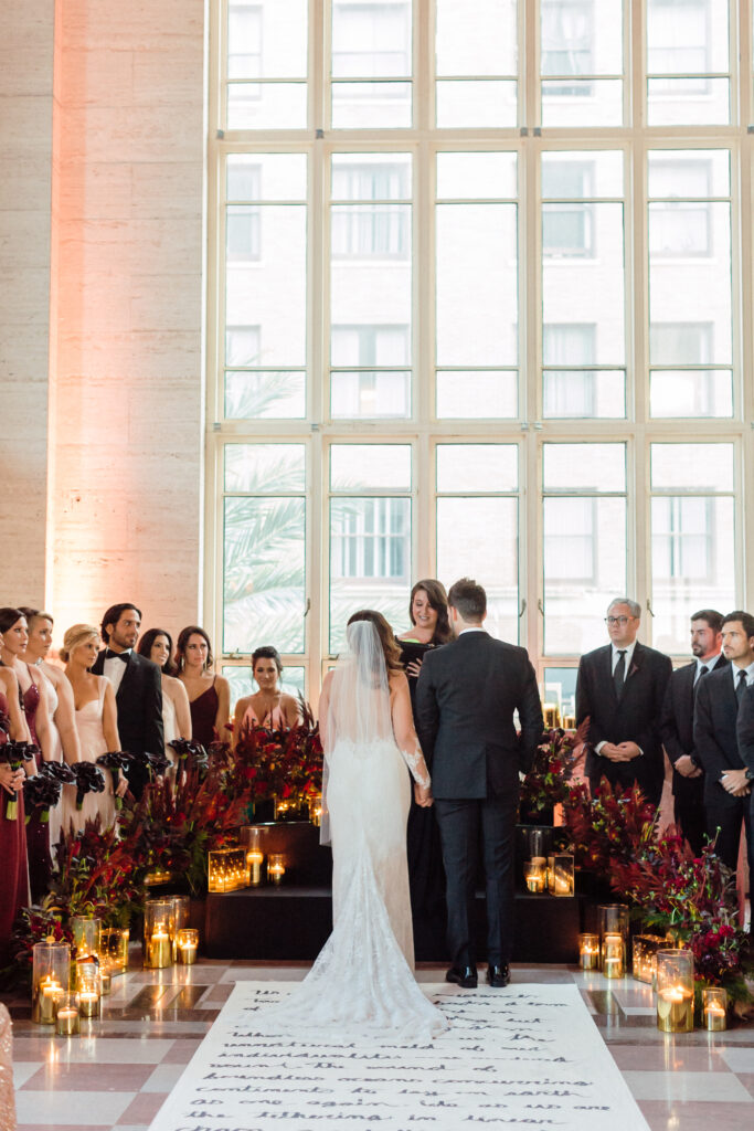 moody wedding décor Miami ceremony with black chairs and candlelight