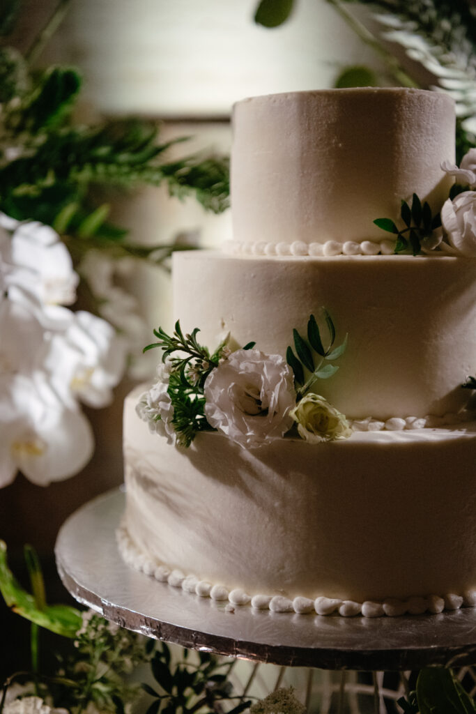 Classic white wedding cake with delicate floral accents.