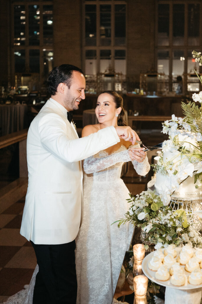 Bride and groom cutting their wedding cake during an elegant Miami reception.