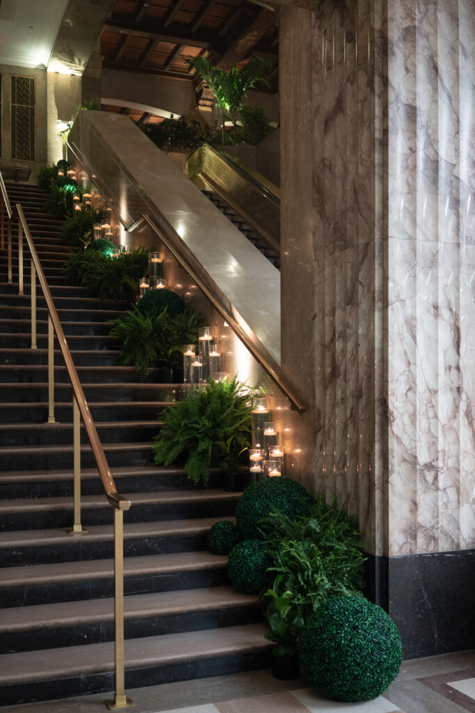 Grand staircase decorated with greenery and candles for a luxury Miami wedding.