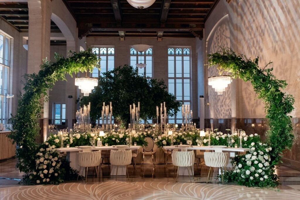 Miami wedding venue reception for Vicky and Marcus Mickey at The Historic Alfred I. duPont Building with candlelit tables, greenery, and white florals.
